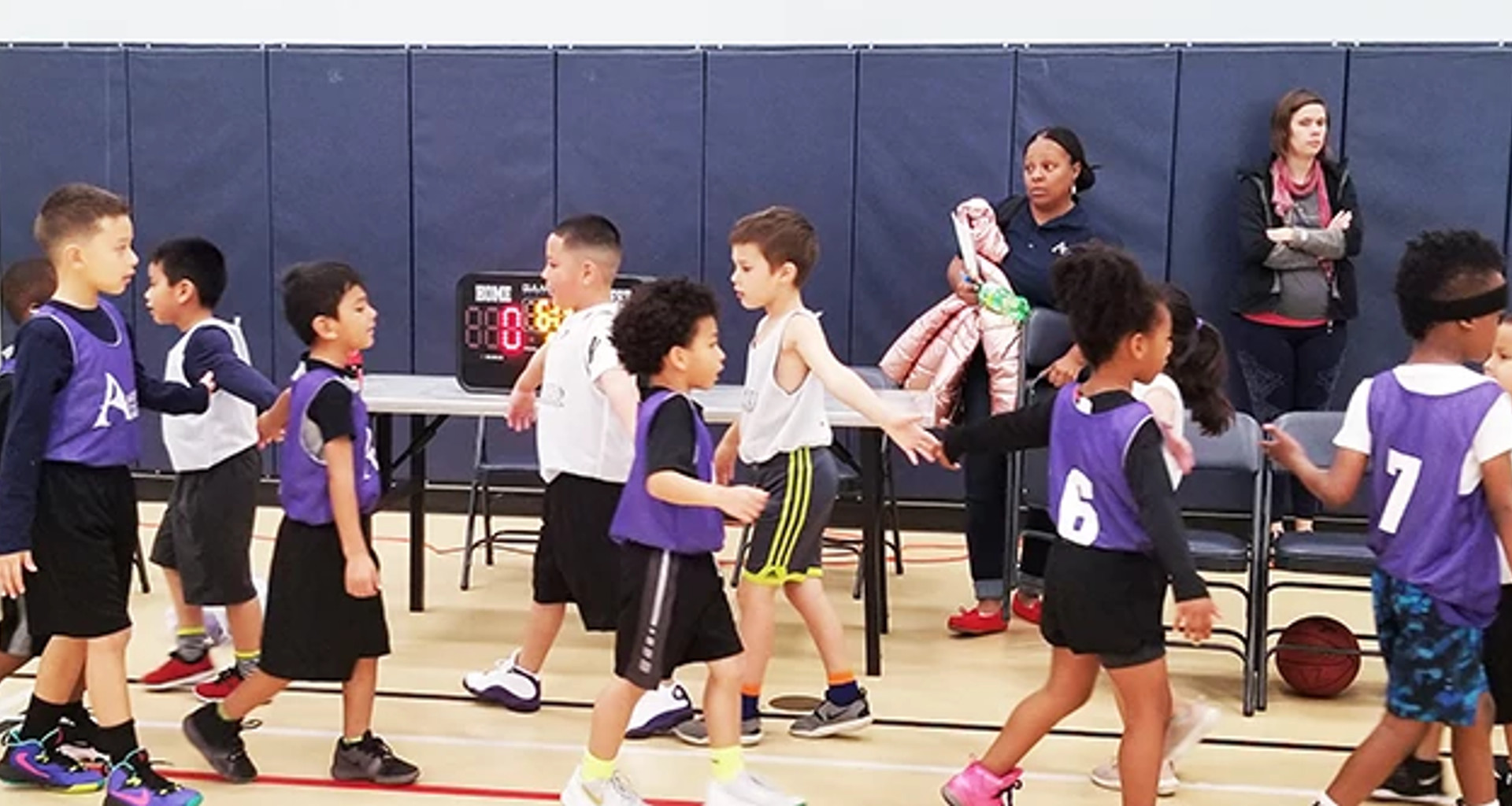 Two youth basketball teams shaking hands